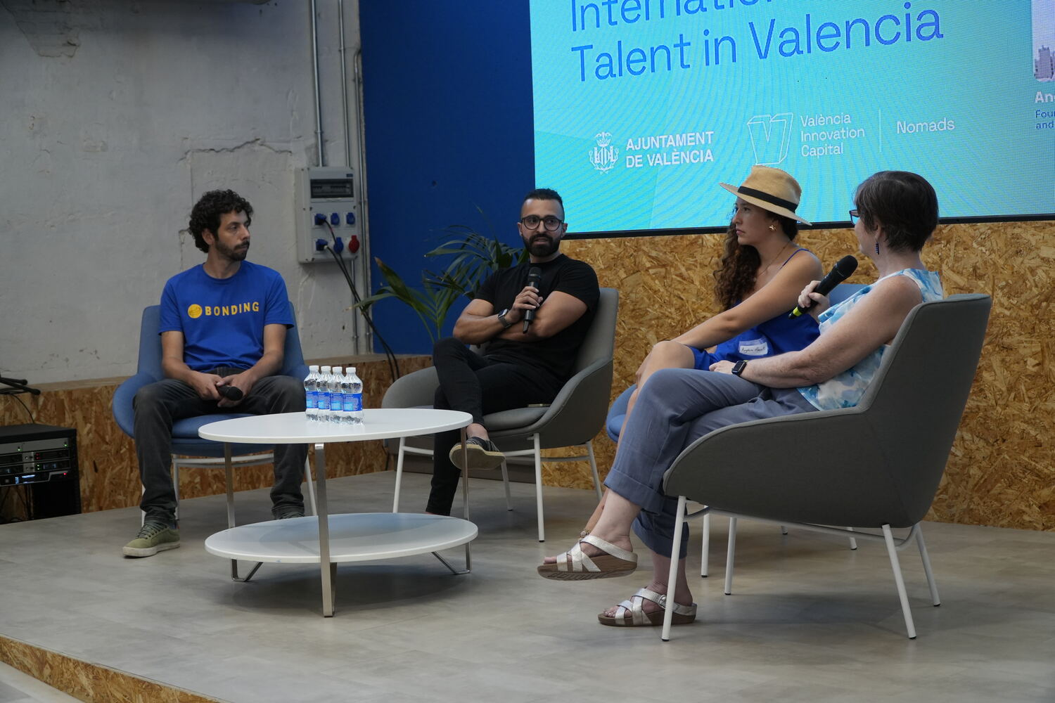 The four panellists seated on stage, Maya Middlemiss holding a microphone with three founders beside her.